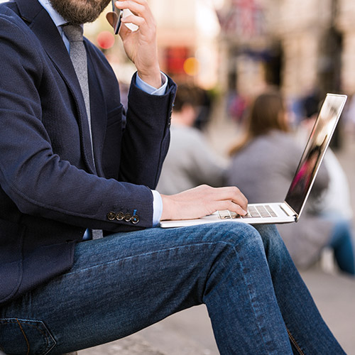 A person holding a smartphone, showcasing the use of a mobile device with VPN protection.